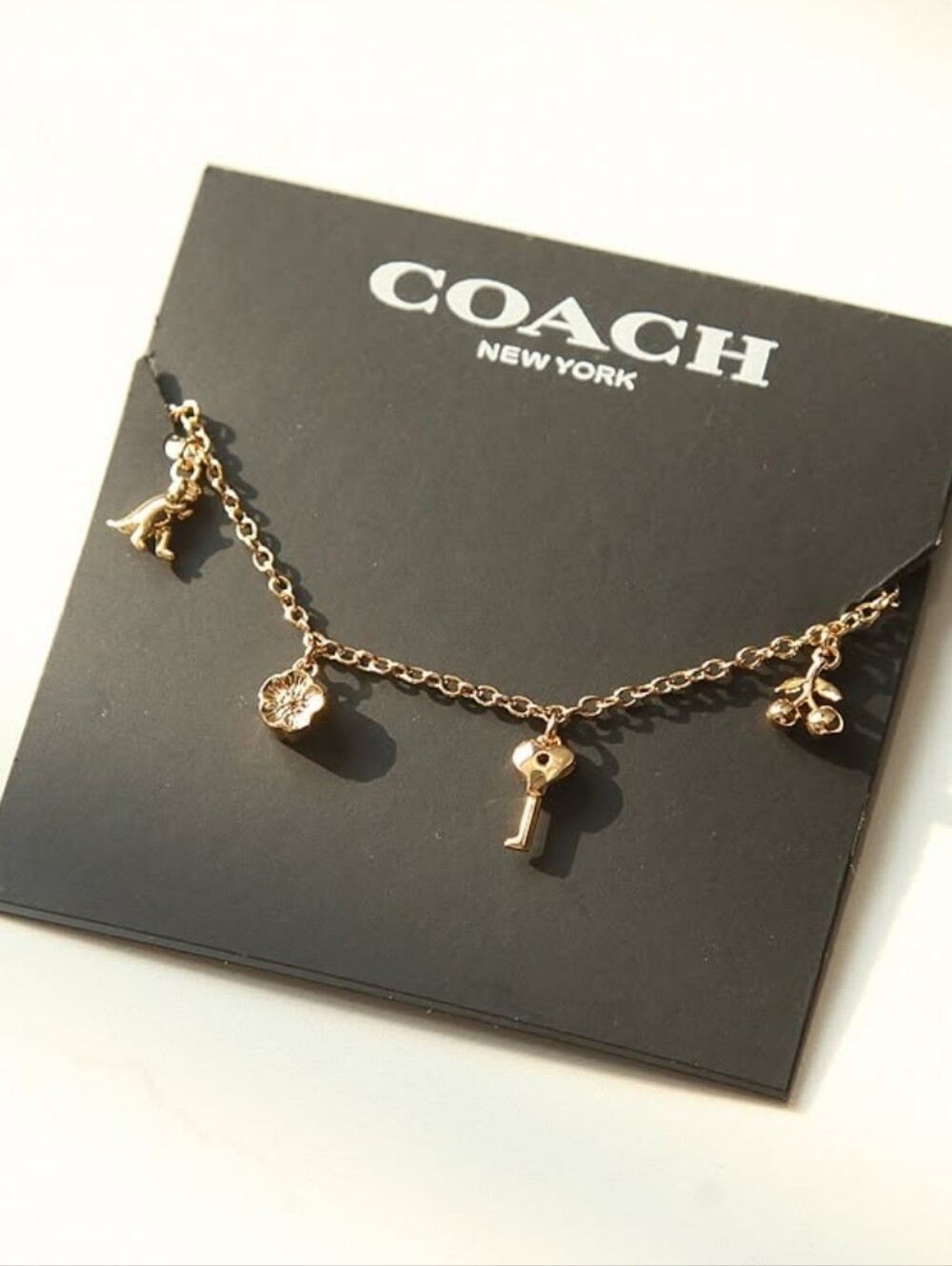 Coach Multi-Charm Gold Tone Necklace